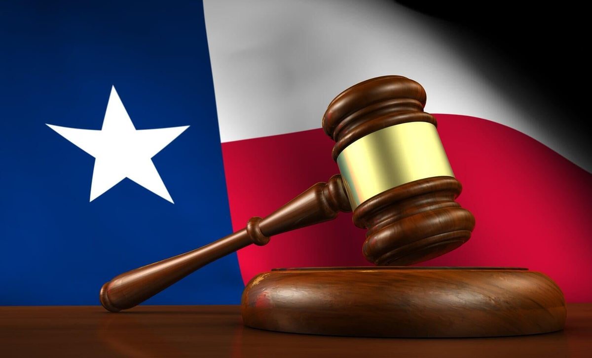 A judge's gavel in front of the Texas flag