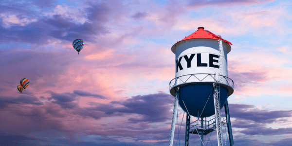 Kyle Texas water tower at sunset with hot air balloons